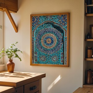 May include: A framed artwork with an elaborate design in teal and gold. The artwork has a detailed circular pattern at its centre. The wooden frame surrounds the artwork. The piece is displayed in a kitchen, adding a touch of artistic flair to the space.