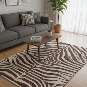 May include: A brown and white zebra-striped rug in a living room. The rectangular rug is placed in front of a dark brown coffee table and a grey sofa. The room has wooden flooring and a large potted plant.