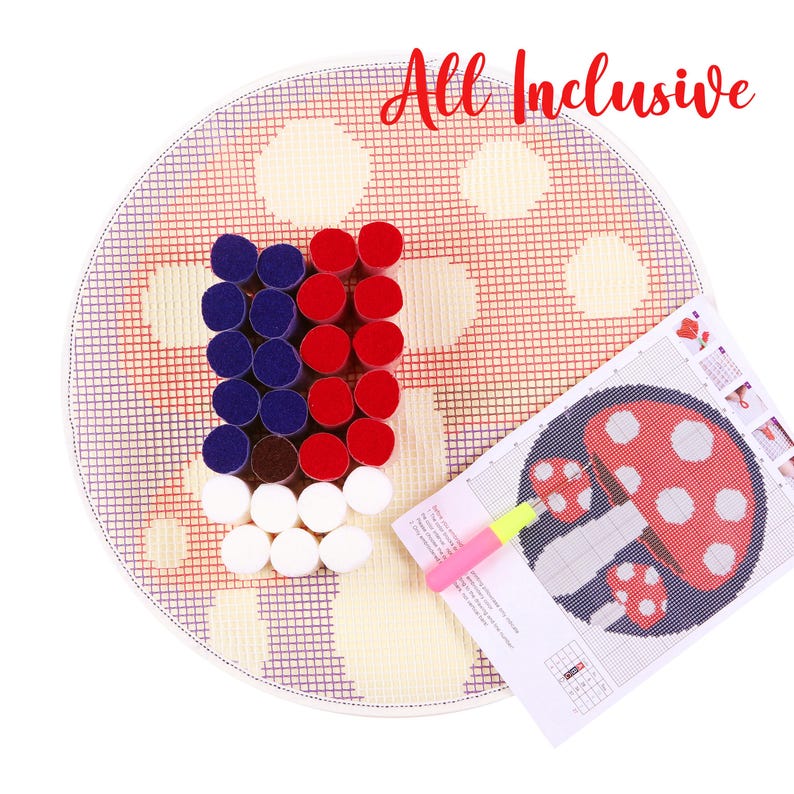 May include: A round, all-inclusive punch needle kit with a red, white, and blue design. The kit includes a needle, a pattern, and a variety of colorful yarn pieces. The text "All Inclusive" is written in red cursive.