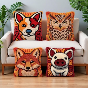 May include: Four square throw pillows featuring textured punch needle designs of a dog, an owl, a fox, and a pig. Each pillow displays a vibrant color palette of orange, red, brown, and cream, with detailed animal faces centered on each cushion.