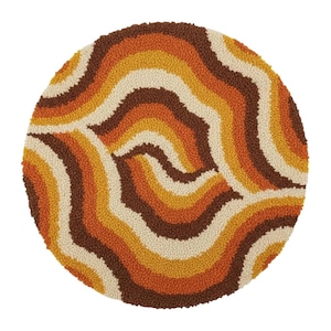 May include: A circular rug with a retro design. It has wavy stripes in brown, orange, yellow, and cream. The rug's texture is looped or tufted, giving a soft appearance. This rug is a decorative item for a living room or bedroom, with a diameter of approximately 120 cm.