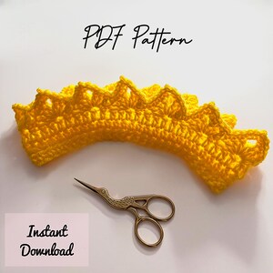 May include: A bright yellow crocheted crown with a scalloped edge, accompanied by gold scissors. The text "PDF Pattern" and "Instant Download" are visible. This image is ideal for craft enthusiasts.