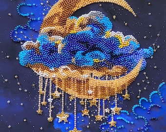 May include: A beaded wall art piece featuring a crescent moon in gold and bronze tones, surrounded by dark blue and light blue clouds. Small beaded star charms hang from the bottom of the moon, set against a dark blue background with scattered beads.