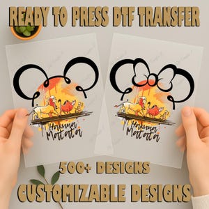 May include: Two ready-to-press DTF transfer sheets featuring a cartoon design with the text "Hakuna Matata". One design has Mickey Mouse ears, the other a bow. The transfers include the text "500+ Designs" and "Customizable Designs".