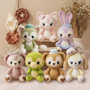 May include: A collection of handmade crochet stuffed animals in various colors. The collection includes a cat, bear, turtle, and bunny. The toys are in shades of pink, green, purple, and brown. Some have hats and bows.