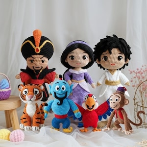 May include: A collection of handmade crochet dolls featuring characters from the animated film Aladdin. The dolls include Aladdin, Jasmine, Jafar, Genie, Abu, Iago, and Rajah. Each doll is brightly colored and detailed, with a whimsical, handcrafted appearance.