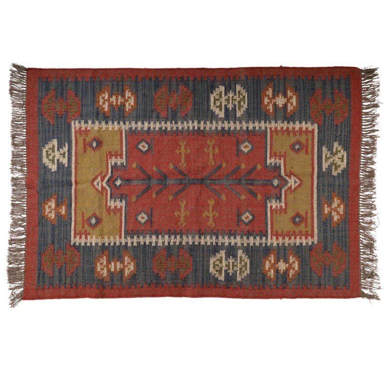May include: Rectangular area rug with a geometric pattern in shades of red, blue, and gold. The rug has a central red field with a detailed design, framed by a blue border and fringed edges. The rug's design is symmetrical.