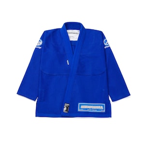 May include: A vibrant blue martial arts uniform, featuring the brand name "SHOYOROLL" on the chest and lower right. The uniform has a wrap-around design with a collar and is made of a durable fabric. Logos are visible on the sleeves.