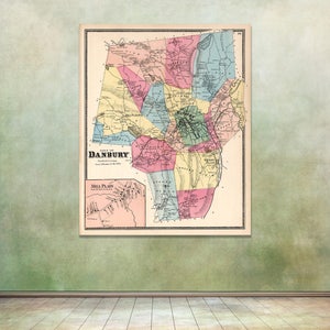 May include: An antique map of Danbury, Connecticut, showing the town's layout and surrounding areas. The map is printed in black and white with colored borders and features the text "Town of Danbury" and "Mill Plain".
