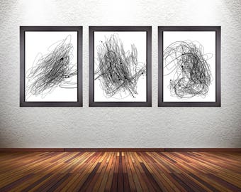 May include: Three black framed abstract art prints with white backgrounds and black line drawings hanging on a white wall. The prints are arranged in a row, with the leftmost print slightly higher than the other two.