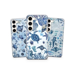 May include: Three phone cases with marine life designs. Each case displays a different pattern of sea creatures, such as turtles, stingrays, seahorses, and starfish, in blue and white hues. The cases have a glossy finish.