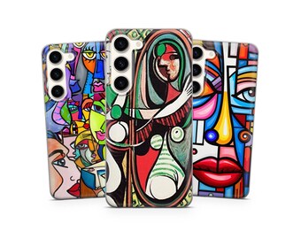 May include: Three phone cases with colorful abstract art designs. The cases feature vibrant colors and bold lines, with faces and geometric shapes. The cases are made of a glossy material and have camera cutouts.