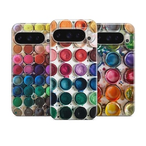 May include: Three phone cases with a watercolor paint palette design. Each case features a different color scheme, including shades of blue, green, yellow, red, and purple. The cases have a glossy finish and a protective design.