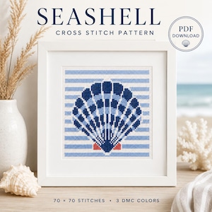 May include: A framed cross-stitch pattern featuring a seashell design in shades of blue and white, set against a striped background. The text "Seashell Cross Stitch Pattern" is displayed at the top. The pattern is 70 x 70 stitches and uses 3 DMC colors.