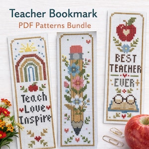 以下が含まれることがあります： 教師をテーマにしたデザインのクロスステッチのしおり3枚。「Teach Love Inspire」と書かれたしおりには虹とリンゴが描かれています。もう1つは花と鉛筆が描かれています。3つ目は「Best Teacher Ever」と書かれ、リンゴとメガネが描かれています。