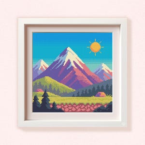 May include: A framed pixel art print depicting a mountain landscape with a blue sky and a yellow sun. The mountains are purple and white, with green and yellow hills in the foreground. A small cabin is visible.