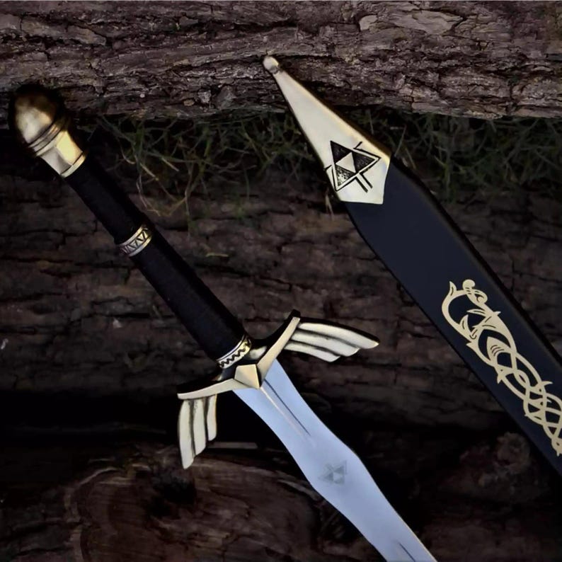 May include: A decorative sword with a silver blade and gold accents. The hilt is black with gold detailing, and the guard features a wing-like design. The scabbard is black with gold Celtic-style patterns and a gold tip.