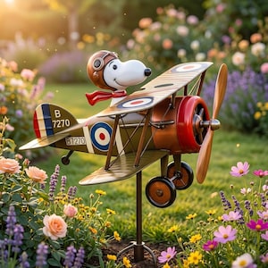 May include: A whimsical garden ornament featuring Snoopy as a pilot in a biplane. The biplane is painted in olive green, brown, and red, with a propeller and the number B7270. Snoopy wears a brown aviator helmet and a red scarf.