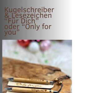 May include: Set of two wooden pens and bookmarks. The pens are light brown with silver accents. The bookmarks have the phrases "Only for you" and "F&uuml;r Dich" engraved on them. The text "Kollegin mit" and a heart are also engraved on the bookmark.