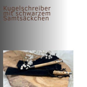 May include: Two wooden pens with engraved text and heart symbols, presented in black velvet pouches. The pens rest on a wooden surface, with the text "VARIANT 4" and "Kugelschreiber mit schwarzem Samts&auml;ckchen" in the background.