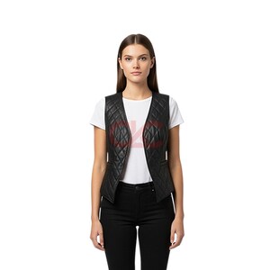 May include: Black quilted leather vest with a V-neck design. The vest features a diamond pattern and two small pockets. The model is wearing a white t-shirt and black pants. The vest is a stylish layering piece.