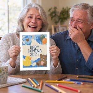 May include: A rectangular white card featuring a pixelated cross-stitch style design with the text BABY COMING 2027. The illustration includes a yellow rubber duck, a brown teddy bear, and blue, green, and orange balloons against a white background.