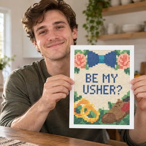 May include: A rectangular diamond painting craft project featuring a white background with the text BE MY USHER? in blue. The design includes a blue bow tie, pink flowers, green leaves, a yellow pretzel, and a brown dress shoe in a pixelated style.