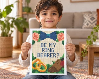 Könnte beinhalten: Ein rechteckiges Kreuzstichmuster auf weißem Stoff mit dem Text BE MY RING BEARER? in Dunkelblau. Das Design zeigt eine blaue Fliege oben, zwei goldene Ringe unten links und einen braunen Schuh unten rechts, umgeben von Rosenmotiven.