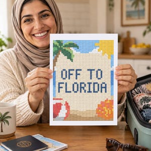 May include: A rectangular diamond painting craft project featuring a beach scene with a palm tree, a yellow sun, a red and white beach ball, and an orange seashell. The text "OFF TO FLORIDA" is printed in dark blue block letters in the center.