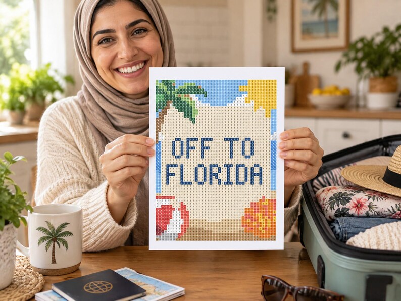 May include: A rectangular diamond painting craft project featuring a beach scene with a palm tree, a yellow sun, a red and white beach ball, and an orange seashell. The text "OFF TO FLORIDA" is printed in dark blue block letters in the center.