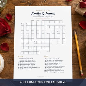 May include: A white paper crossword puzzle titled Our Story in Clues with the names Emily & James and the date September 14, 2016. The puzzle includes numbered across and down clues related to personal history and a small heart icon at the top.