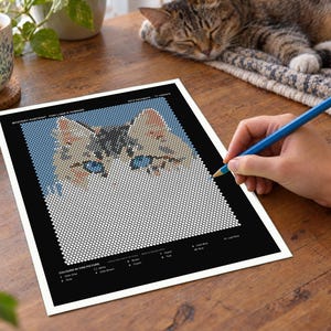 May include: A mystery portrait activity sheet featuring a grid of white circles that form a cat's face with blue eyes and brown ears. The black border includes a color key with labels like White, Dark Gray, Pink, Brown, Green, Peach, Teal, Dark Blue, Blue, and Light Blue.