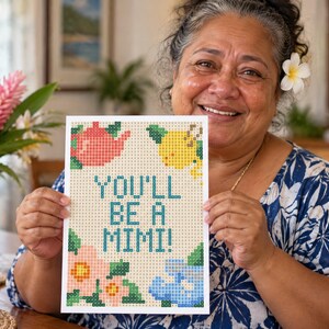 May include: A rectangular card featuring a pixelated design with the text YOU'LL BE A MIMI! in teal. The design includes a pink teapot, a yellow lemon, a pink flower, and a blue floral shape, all set against a light beige grid background.