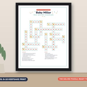 May include: A framed baby shower crossword puzzle print titled Baby Miller, dated April 12, 2027. The white puzzle features orange text in a grid with clues listed below. The print is labeled as an 8x10 keepsake print, ready to frame.