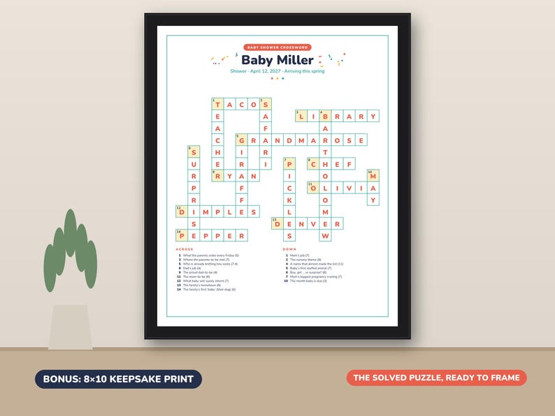 May include: A framed baby shower crossword puzzle print titled Baby Miller, dated April 12, 2027. The white puzzle features orange text in a grid with clues listed below. The print is labeled as an 8x10 keepsake print, ready to frame.