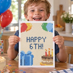 May include: A rectangular diamond painting craft project featuring a grid pattern with the text HAPPY 6TH! in blue. The design includes colorful pixelated illustrations of balloons, a blue gift box, and a birthday cake with lit candles.