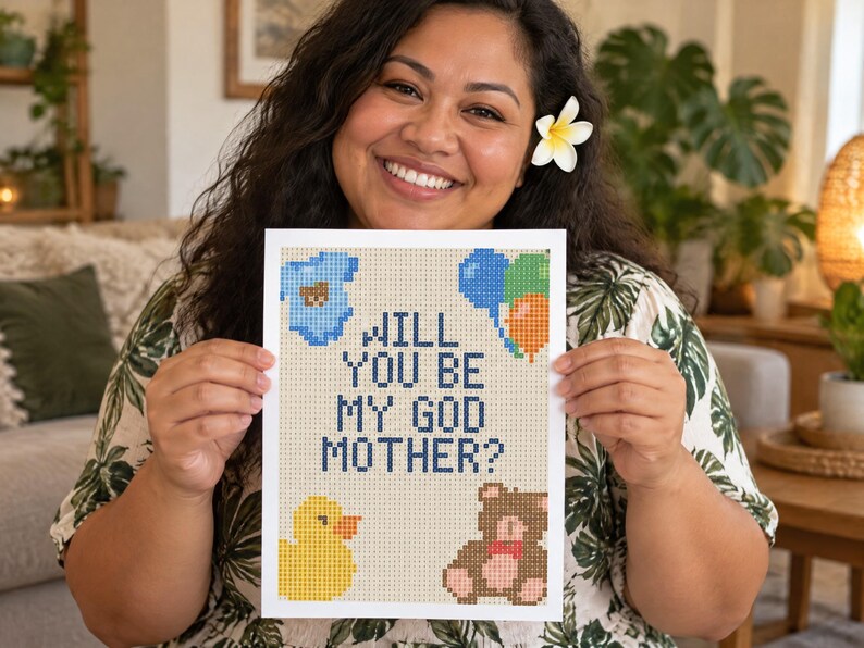 May include: A rectangular white card featuring a pixelated cross-stitch design with the text WILL YOU BE MY GOD MOTHER? in dark blue. The design includes a light blue baby onesie, a cluster of blue, green, and orange balloons, a yellow duck, and a brown teddy bear.