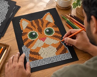 May include: A diamond painting kit featuring a tabby cat design on a black background. The image shows a partially completed mosaic of a cat face with orange, brown, and white circular gems, large green eyes, and a pink nose on a black adhesive sheet.