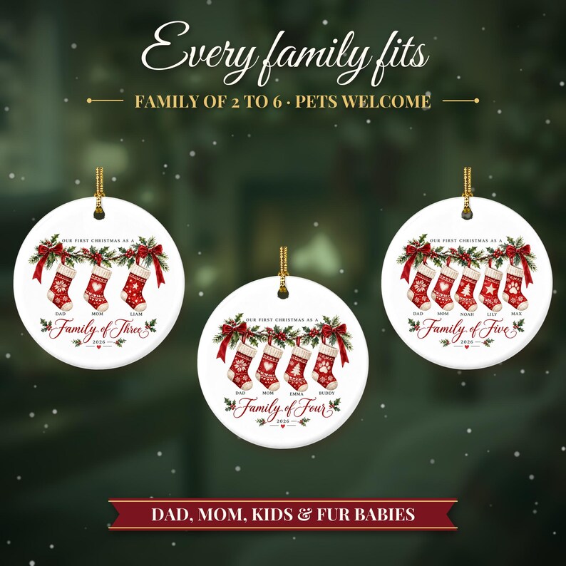 May include: Three round white ceramic ornaments featuring red and white Christmas stockings hanging from a green garland with red bows. Text includes "Every family fits", "Family of three", "Family of four", "Family of five", and "2026".