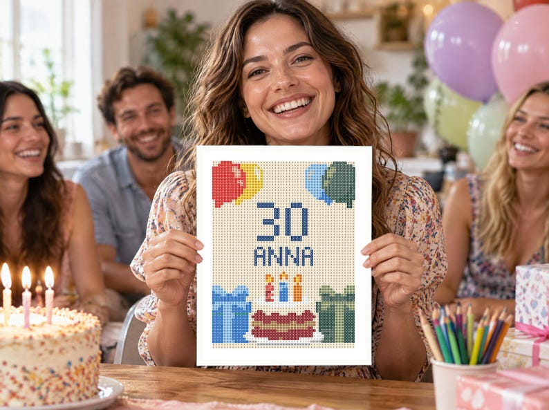 May include: A rectangular white card featuring a pixelated cross-stitch design of a birthday celebration. The center displays the number 30 and the name Anna in blue text, surrounded by colorful balloons, two wrapped gift boxes, and a birthday cake.