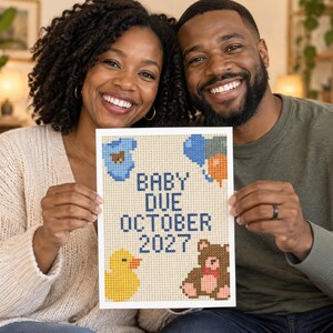 May include: A rectangular diamond painting craft featuring the text BABY DUE OCTOBER 2027 in dark blue. The design includes a blue baby onesie, a cluster of blue and orange balloons, a yellow rubber duck, and a brown teddy bear on a light background.