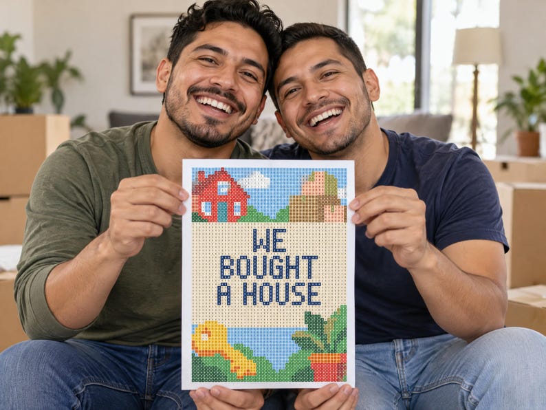 May include: A rectangular print featuring a pixel art design with a red house, brown boxes, a yellow key, and a green potted plant. The text WE BOUGHT A HOUSE is printed in dark blue pixelated letters in the center of the white-bordered artwork.