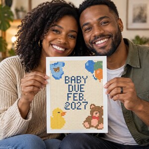 May include: A rectangular sign featuring a pixelated design with the text BABY DUE FEB. 2027 in dark blue. The design includes a blue baby onesie, a cluster of blue, green, and orange balloons, a yellow rubber duck, and a brown teddy bear.