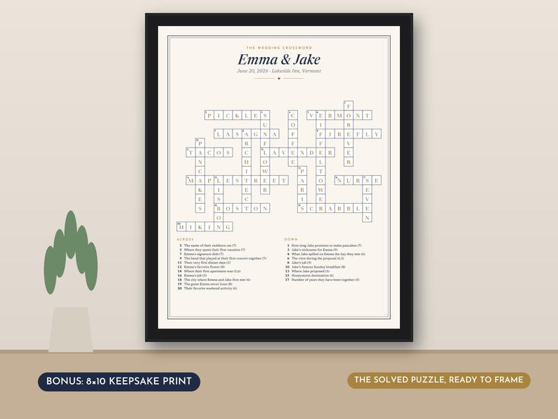 May include: A framed wedding crossword puzzle print titled Emma & Jake, dated June 20, 2026, in Lakeside Inn, Vermont. The white print features black text and grid lines, with numbered clues listed below the puzzle. The frame is black with a thin border.