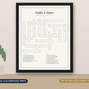 May include: A framed crossword puzzle print titled Our Story in Glass featuring the names Emily & James and the date September 14, 2016. The puzzle includes words like Penguins, Chicago, Risotto, Santorini, Peonies, Lighthouse, and Iceland.