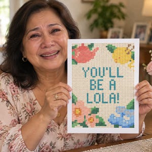 May include: A rectangular diamond painting canvas featuring the text YOU'LL BE A LOLA! in blue block letters. The design includes a pink teapot, a yellow lemon, and pink and blue floral motifs, all composed of a grid of small colored squares.