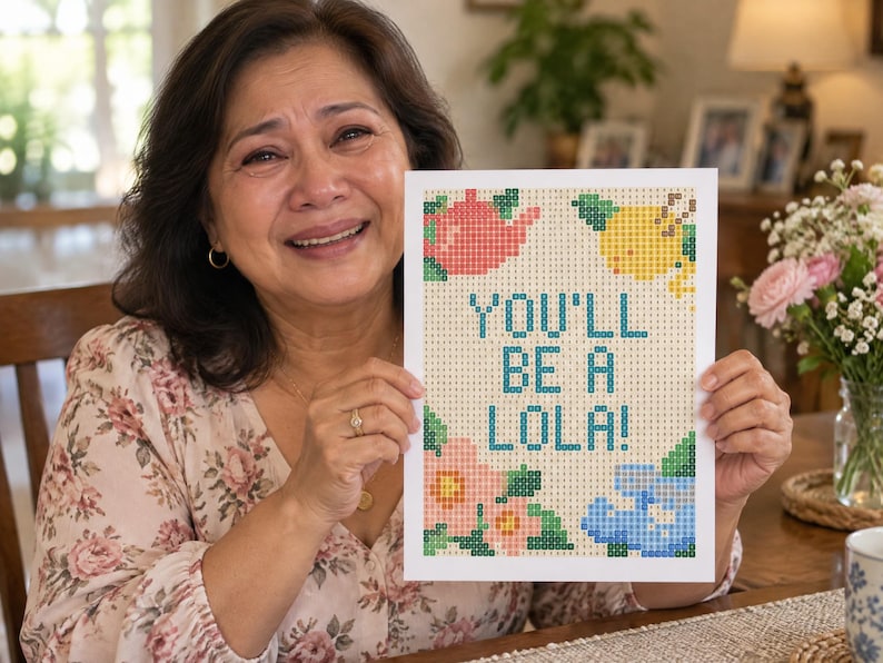 May include: A rectangular diamond painting canvas featuring the text YOU'LL BE A LOLA! in blue block letters. The design includes a pink teapot, a yellow lemon, and pink and blue floral motifs, all composed of a grid of small colored squares.