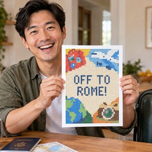 May include: A rectangular diamond painting craft project featuring a pixelated design with the text OFF TO ROME! in dark blue. The artwork includes colorful icons of a globe, a camera, a suitcase, and an airplane against a light beige background.