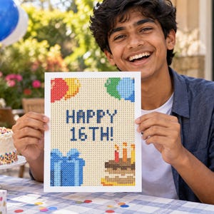 May include: A rectangular sign featuring a pixelated design with the text HAPPY 16TH! in dark blue. The graphic includes red, yellow, green, and blue balloons, a blue gift box with a bow, and a brown birthday cake with lit candles.