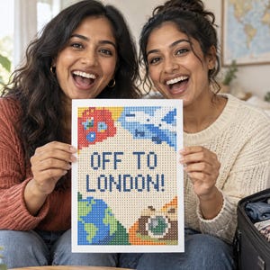 May include: A rectangular diamond painting craft project featuring the text OFF TO LONDON! in dark blue block letters. The design includes colorful pixelated icons of a red double-decker bus, a blue airplane, a green and blue globe, and a camera.